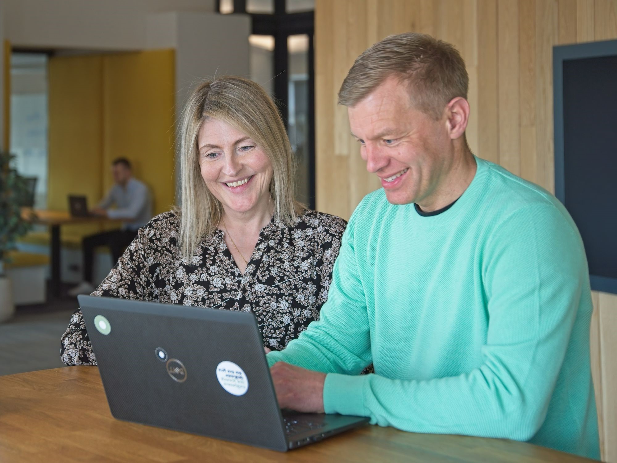 two happy people working